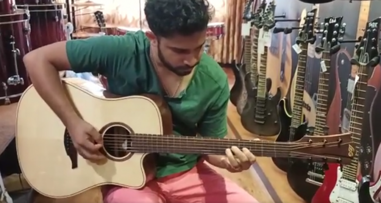 A very talented and well known Musician Mr. Patson Pereira  with a newly arrived LAG GUITAR (TRAMONTANE SERIES) at Symphony showroom in Mangalore.